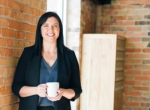Smiling woman holding coffee