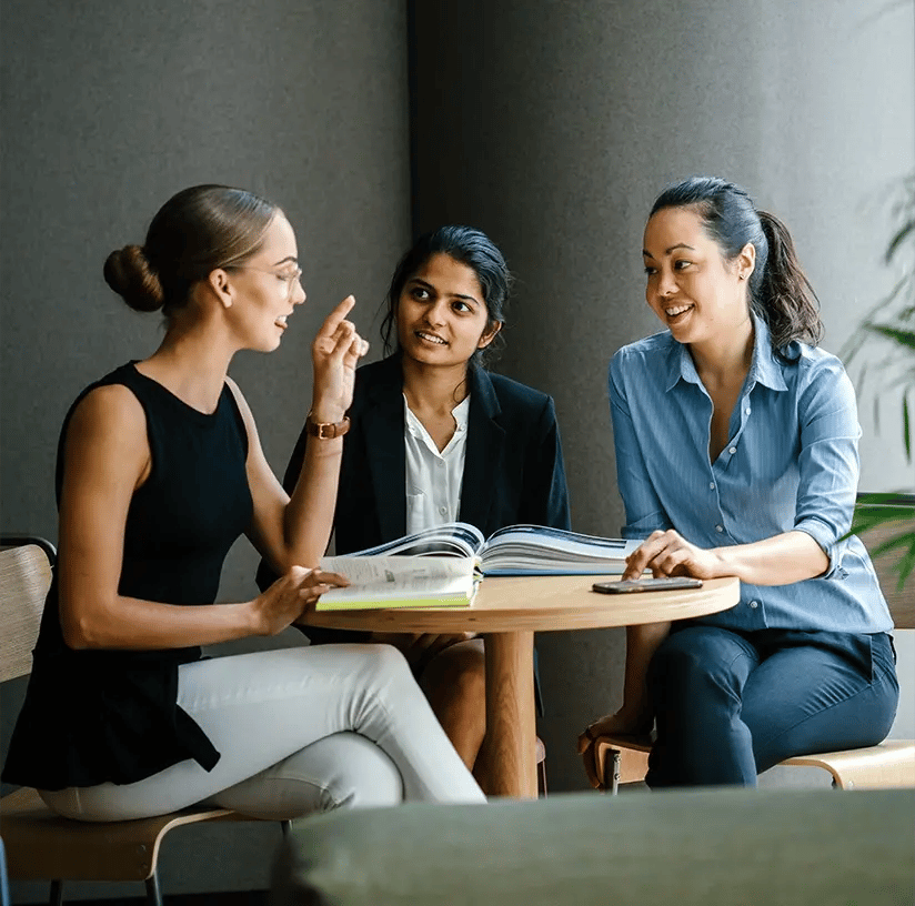 A photo of 3 female colleagues in a meeting