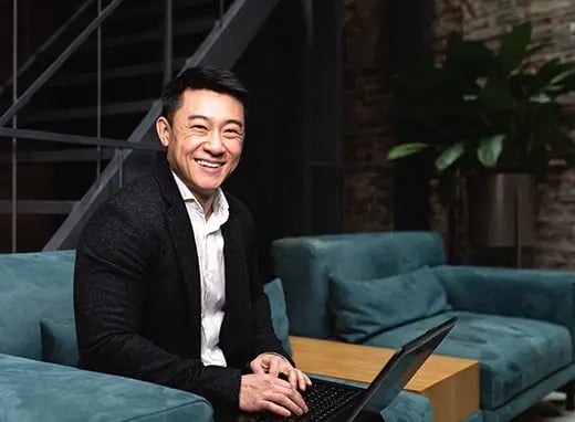 A photo of a business man smiling at the camera