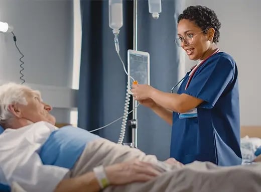 A nurse tends to an elderly patient