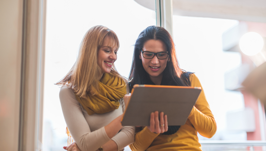 Two women reviewing something on a tablet