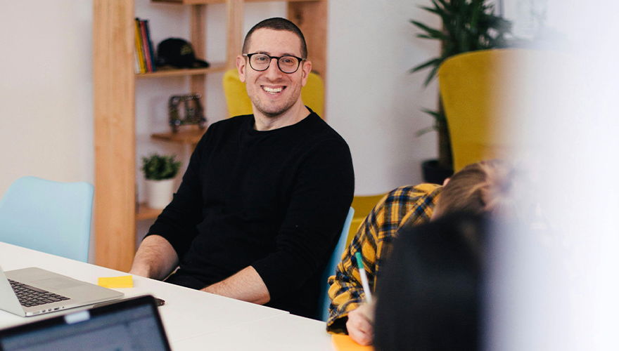 Caucasian male wearing glasses and smiling.