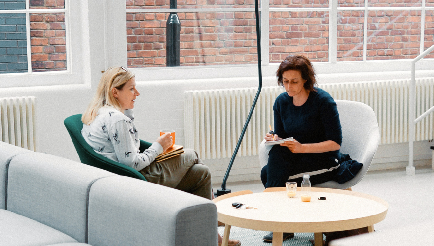 People in an office sitting collaborating together