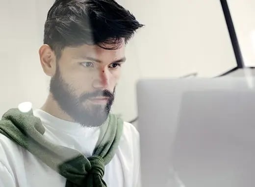 A photo of a man working on a computer