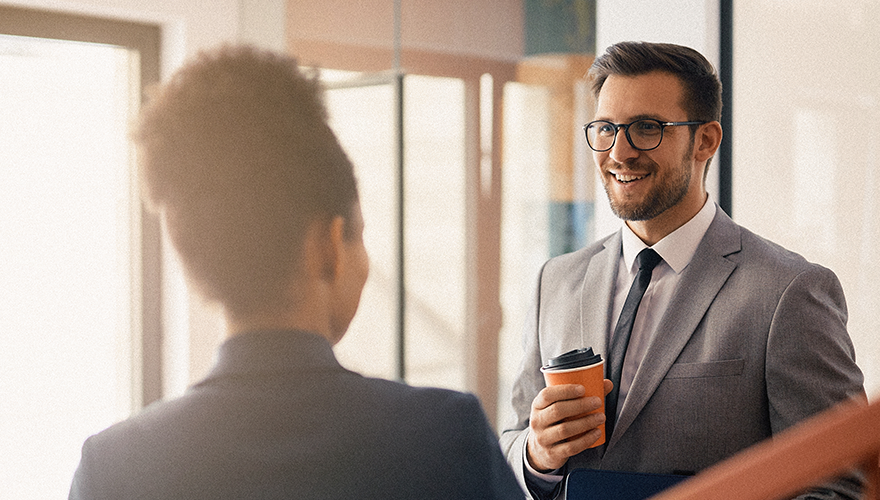 Photo of a business man and woman talking