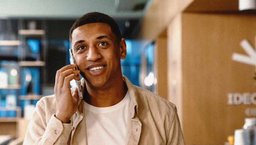 Young man on the phone discussing workforce planning and outsourcing options