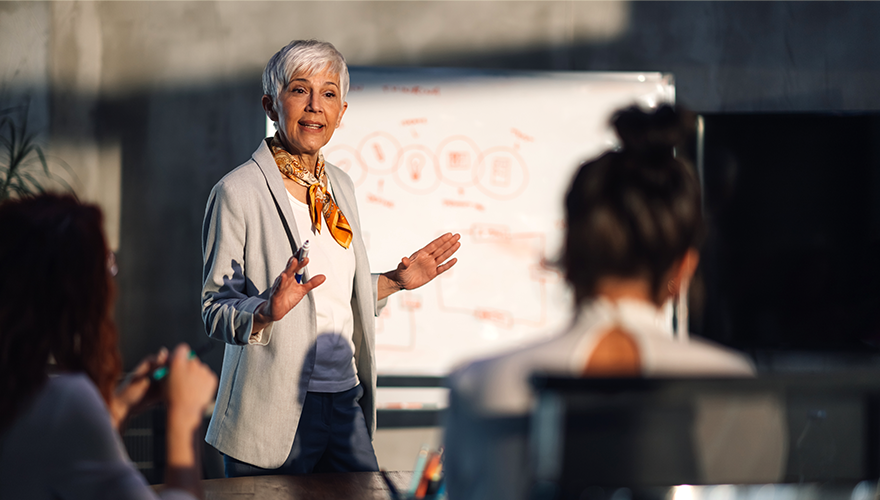 A woman professor conducting a lecture to students