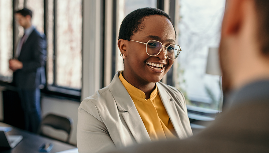 Woman smiling at her laptop while working
